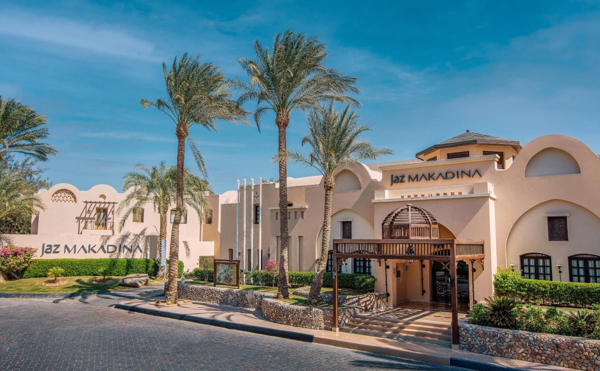 JAZ Makadina entrance with an arched facade and palm trees.