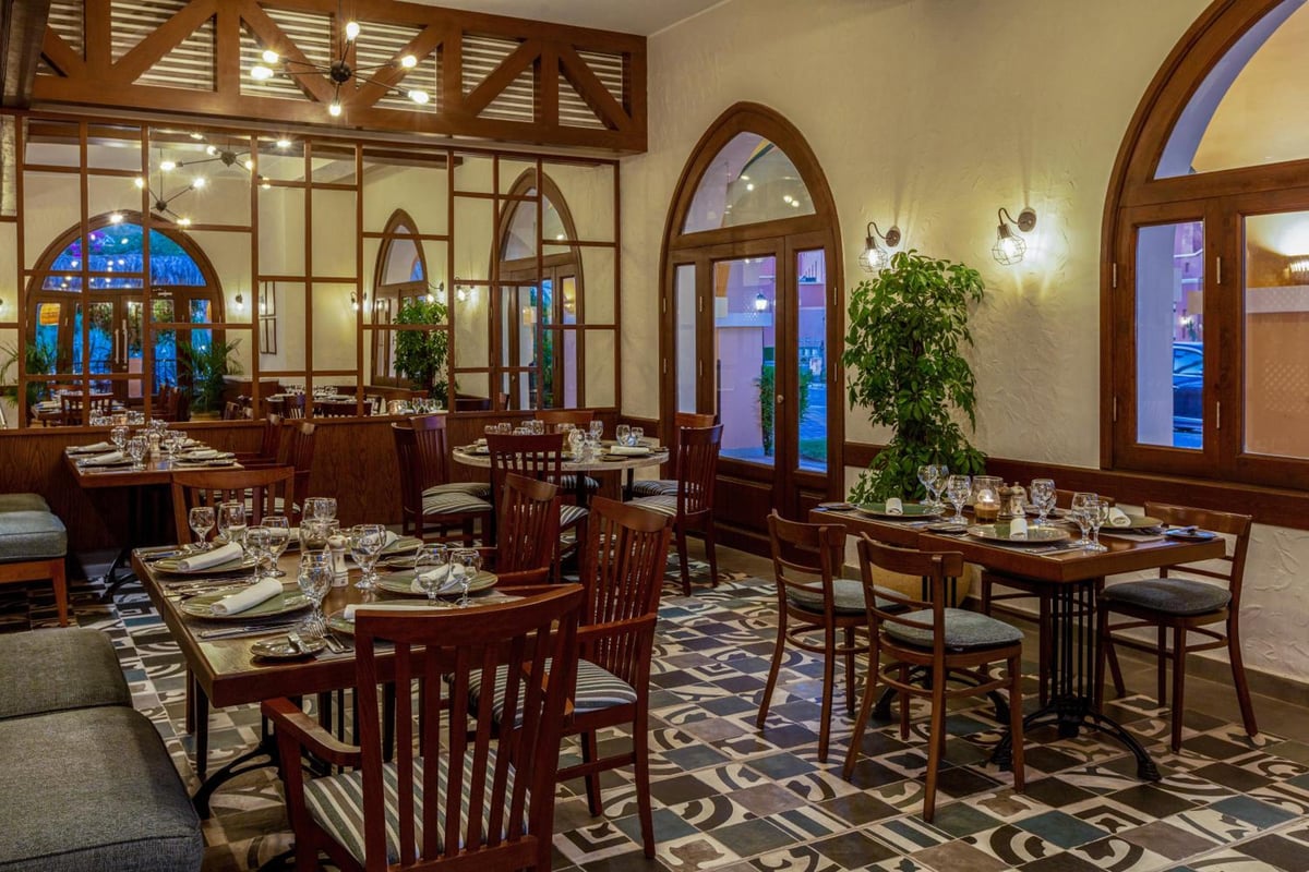 JAZ Makadina restaurant dining room with arched windows and patterned tile floor.