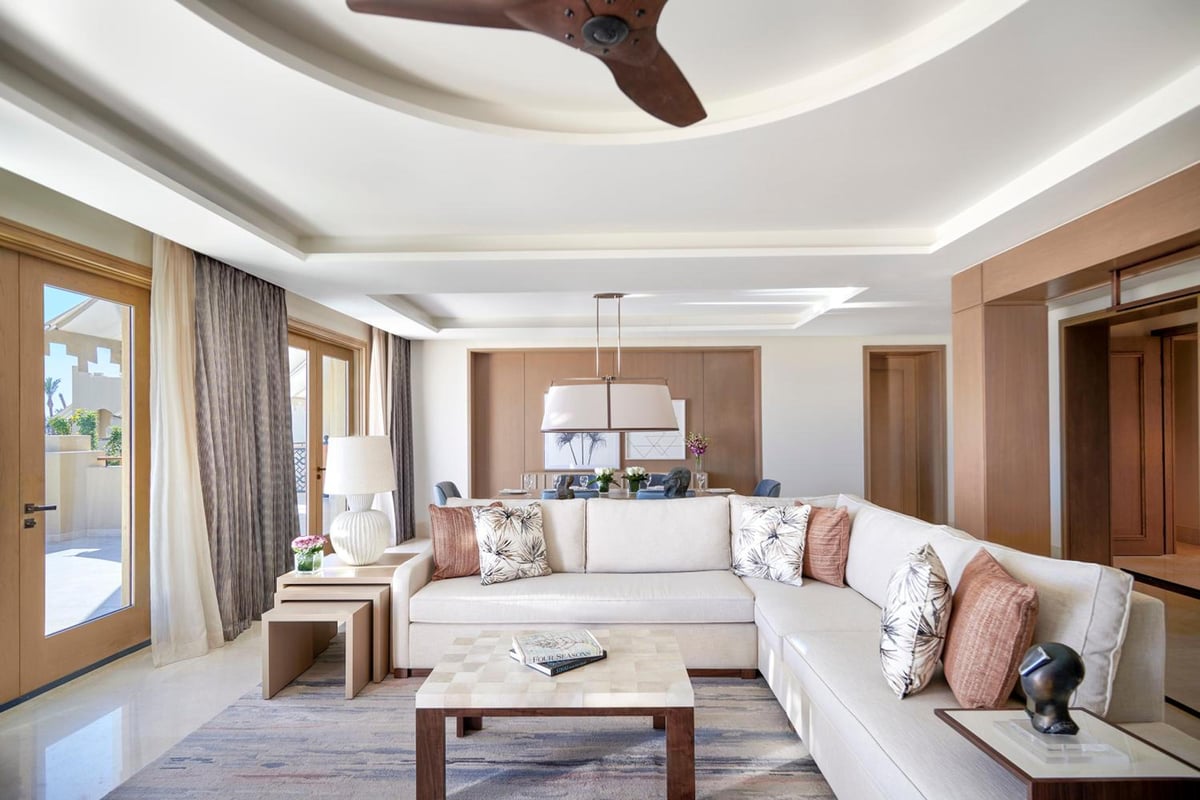 Four Seasons Resort Sharm El Sheikh living room with a sectional sofa and tall windows.