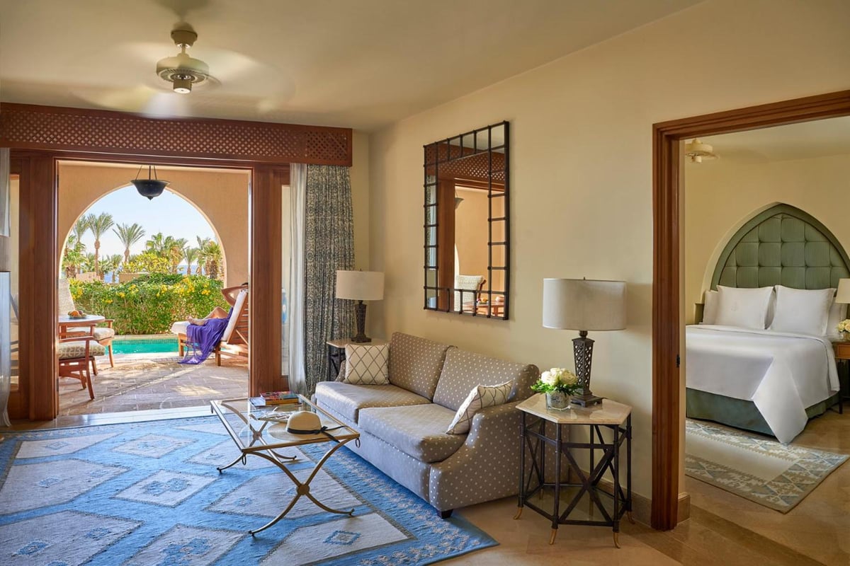 Four Seasons Resort Sharm El Sheikh suite sitting area with a sofa and arched patio doorway.