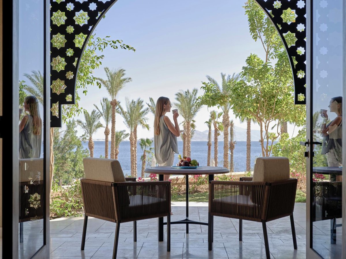 Four Seasons Resort Sharm El Sheikh terrace with wicker chairs and a sea view.