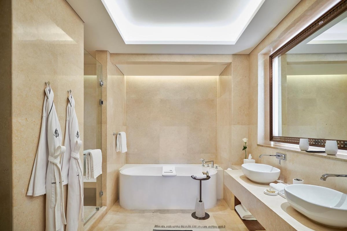 Four Seasons Resort Sharm El Sheikh bathroom with a freestanding bathtub and twin vessel sinks.