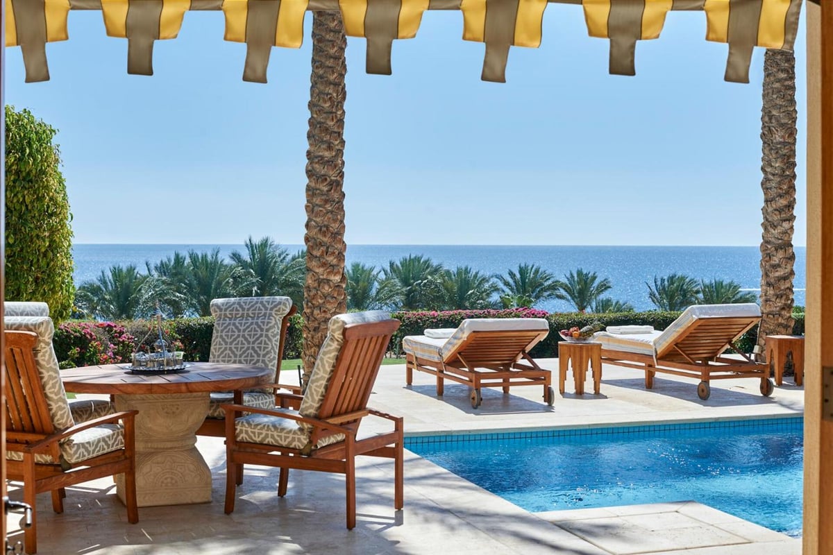 Four Seasons Resort Sharm El Sheikh pool terrace with a swimming pool and sea views.