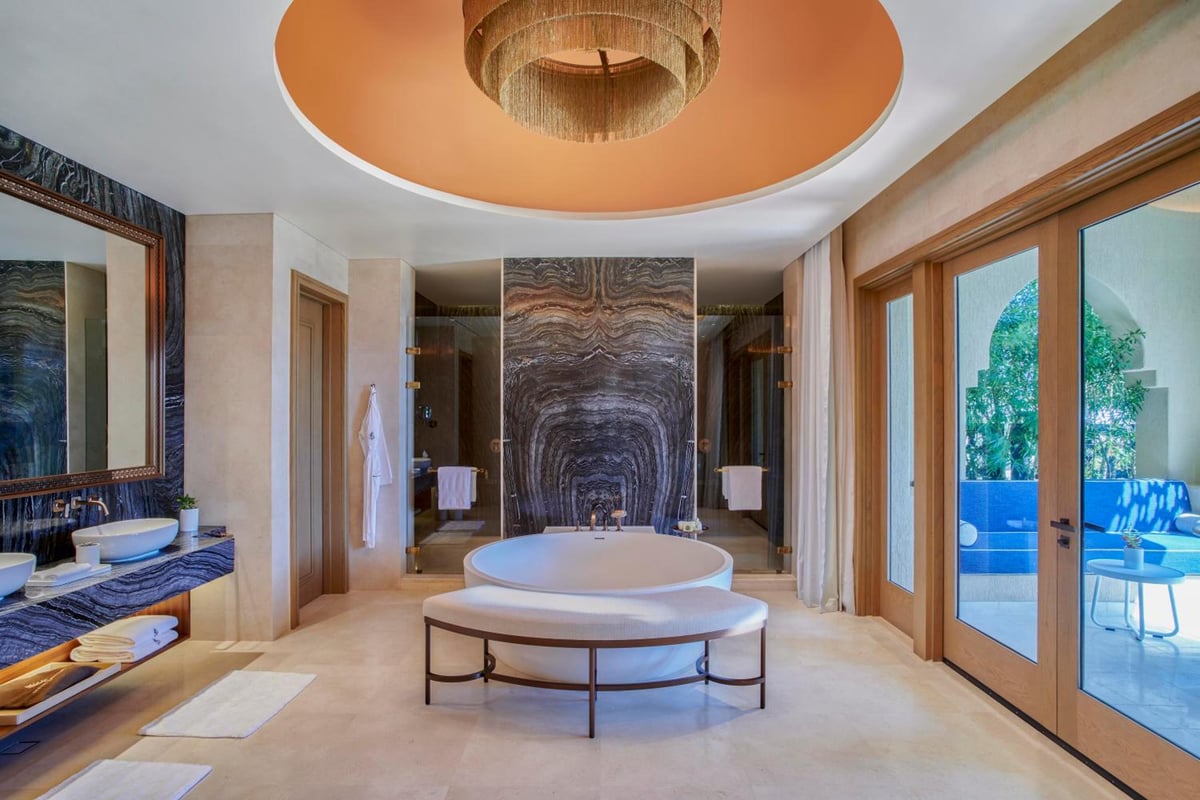 Four Seasons Resort Sharm El Sheikh bathroom with a freestanding tub and marble feature wall.