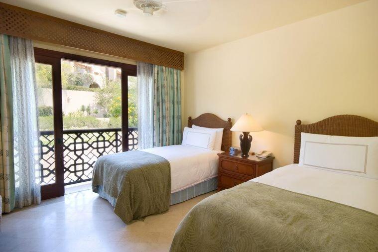 Four Seasons Resort Sharm El Sheikh twin bedroom with two beds and balcony doors.