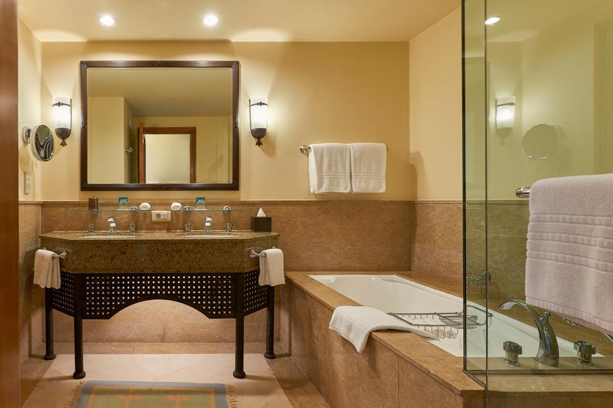 Four Seasons Resort Sharm El Sheikh bathroom with a wood vanity and glass shower enclosure.