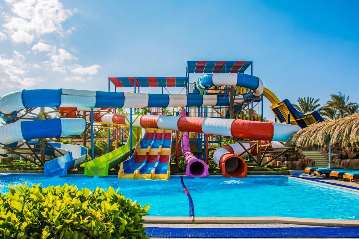 Sunrise Aqua Joy Resort water park pool with colourful slides and blue water.