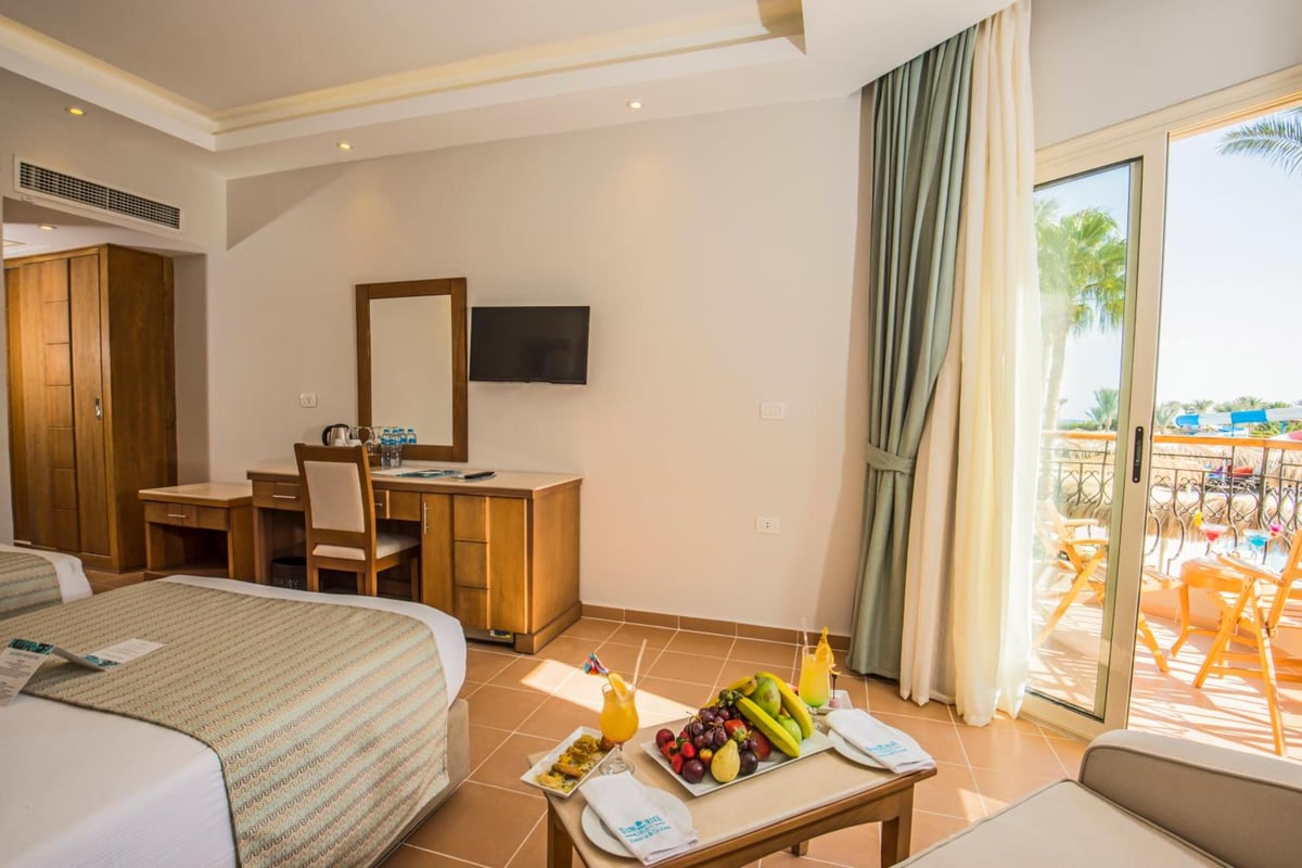 Sunrise Aqua Joy Resort guest room with twin beds and patio doors.
