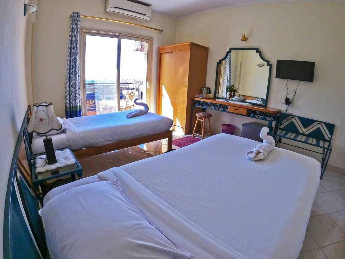 New Memnon Hotel Luxor twin room with two beds and glass balcony doors.