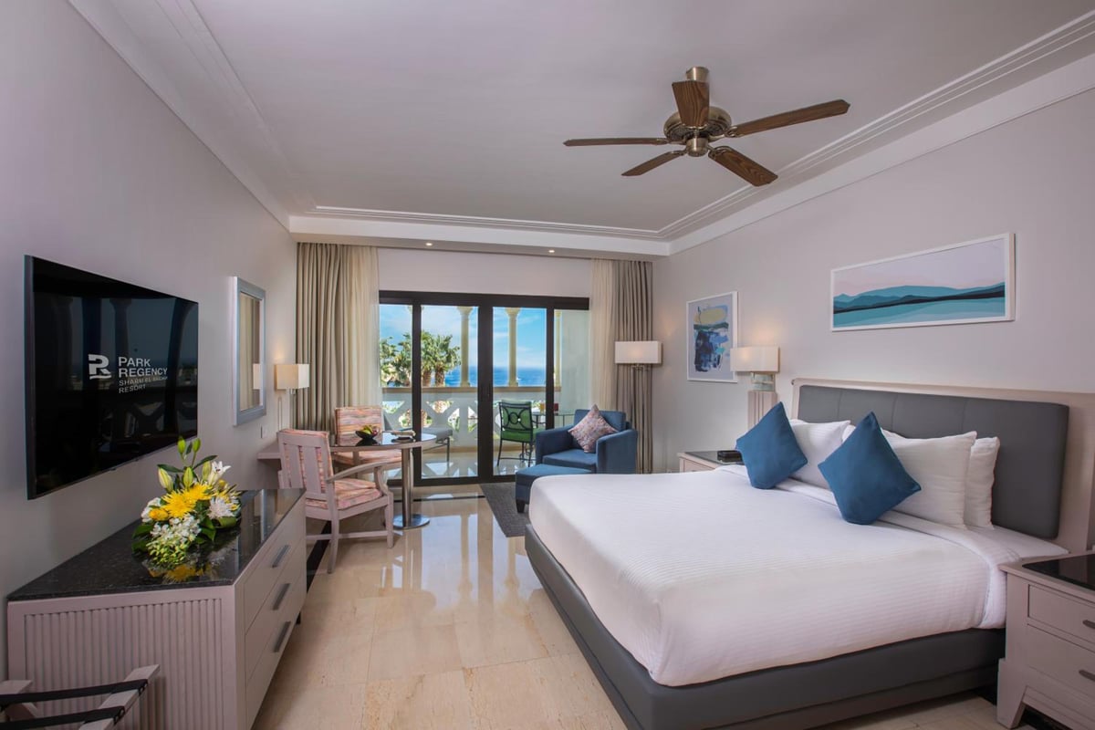 Park Regency Sharm El Sheikh Resort guest room with a large bed and sliding glass doors.