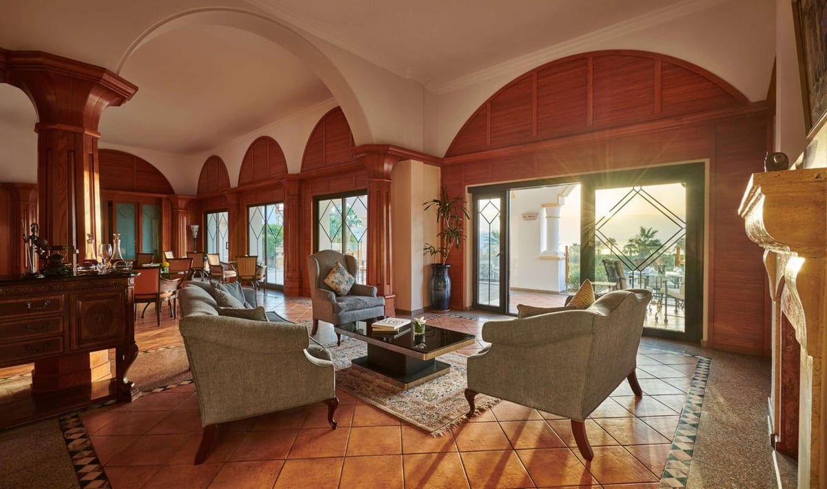 Park Regency Sharm El Sheikh Resort lounge with wooden arches and upholstered chairs.
