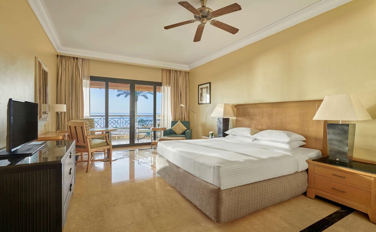 Park Regency Sharm El Sheikh Resort guest room with a king bed and sliding glass doors.