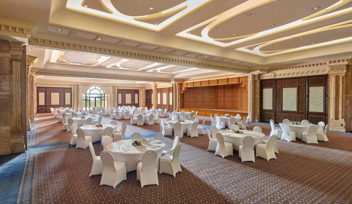 Park Regency Sharm El Sheikh Resort ballroom with round tables and an ornate ceiling.