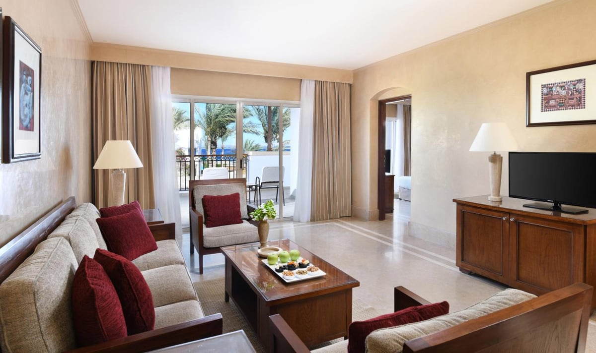 JAZ Dahabeya living room with upholstered seating and glass doors.