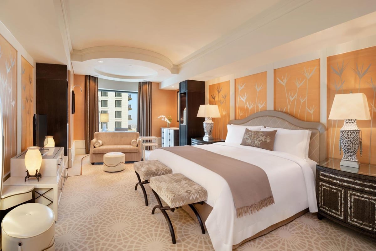 St. Regis Cairo guest room with a king bed and a sitting area.