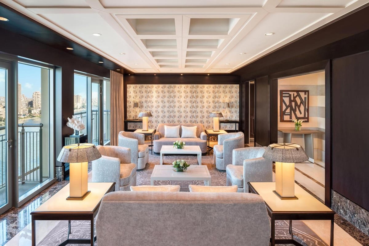St. Regis Cairo living room with tall windows and upholstered seating.
