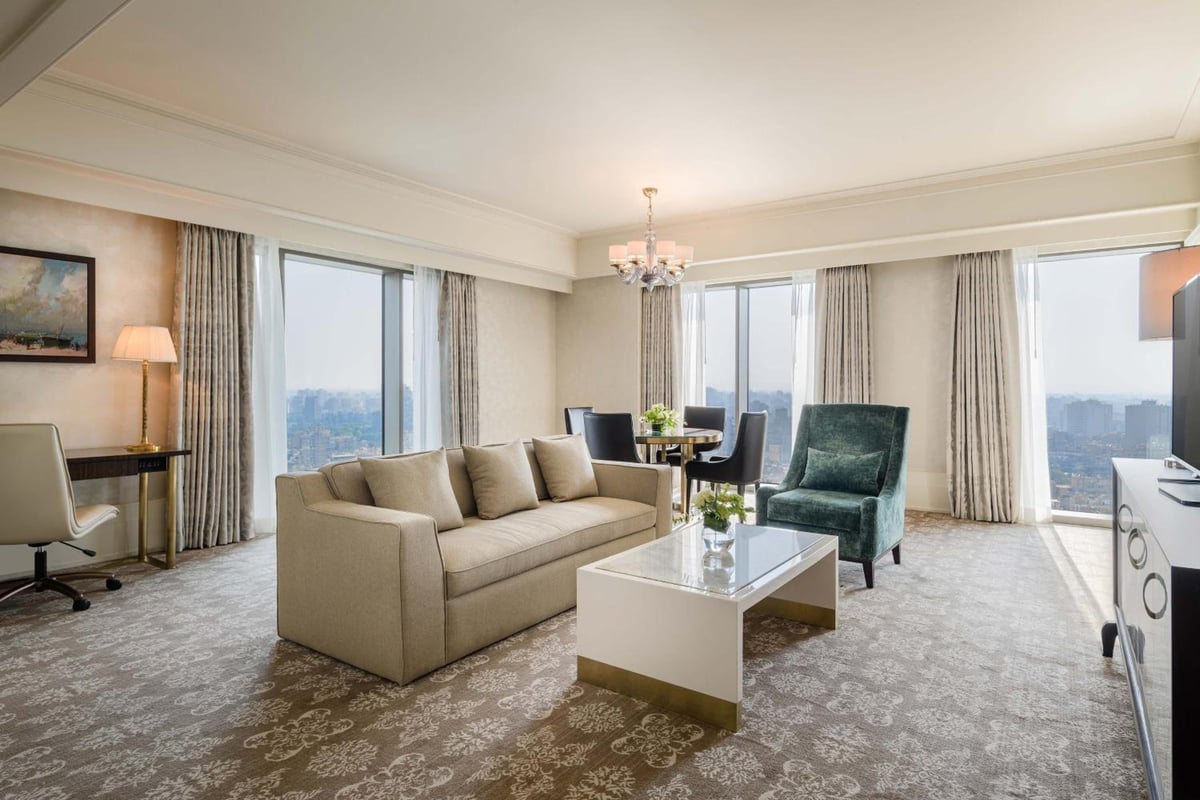 St. Regis Cairo suite living room with large windows and a seating area.