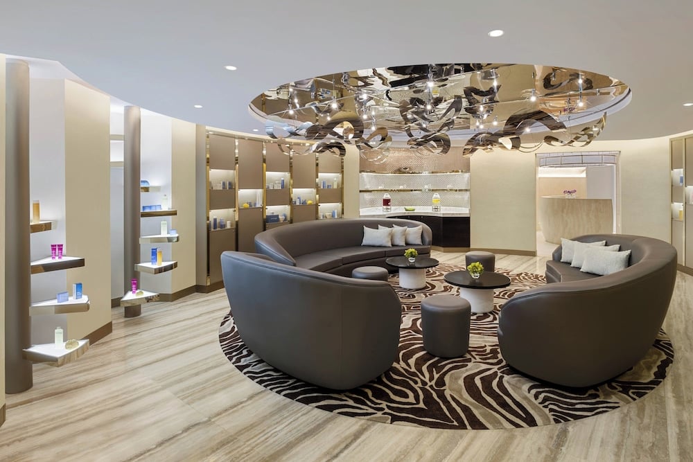 St. Regis Cairo spa lounge with curved seating and mirrored centrepiece.