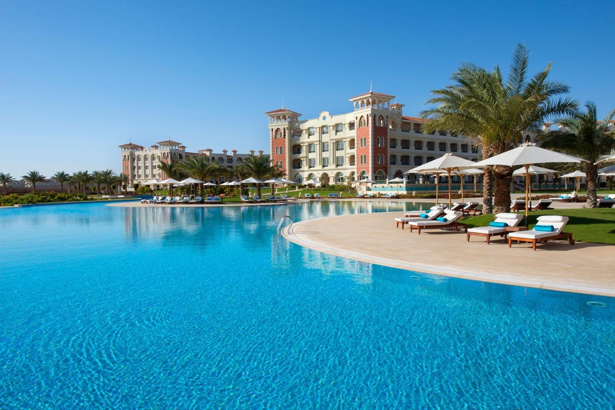 Baron Palace Sahl Hasheesh outdoor pool with a curved edge and shaded loungers.