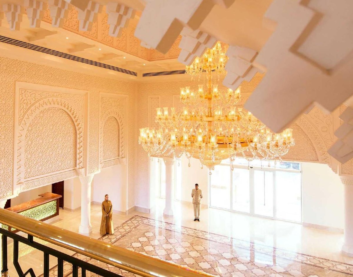 Baron Palace Sahl Hasheesh lobby with a chandelier and carved walls.