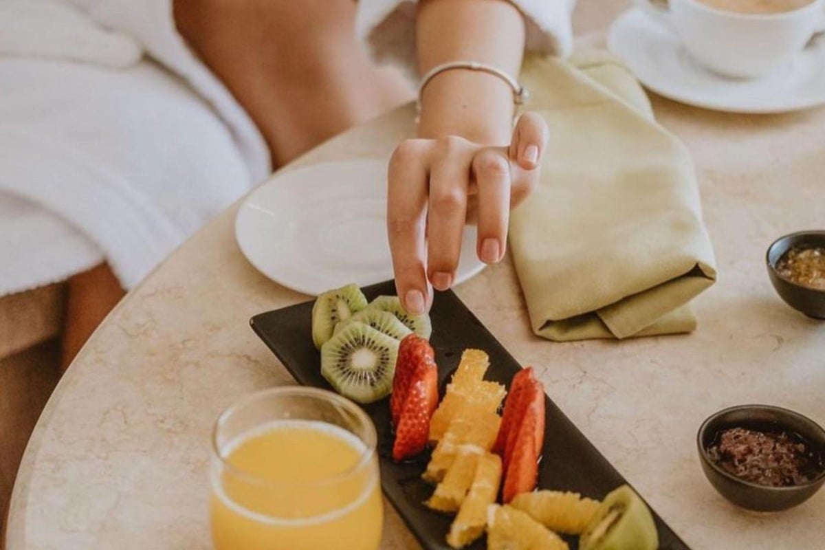 Baron Resort Sharm El Sheikh breakfast table with sliced fruit and orange juice.