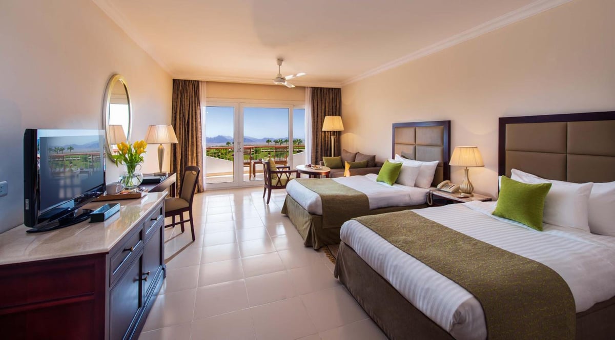 Baron Resort Sharm El Sheikh twin room with two beds and balcony doors.