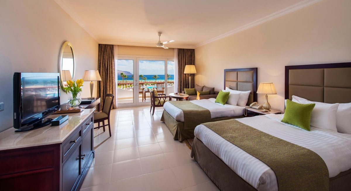 Baron Resort Sharm El Sheikh guest room with two beds and a sea-view balcony.