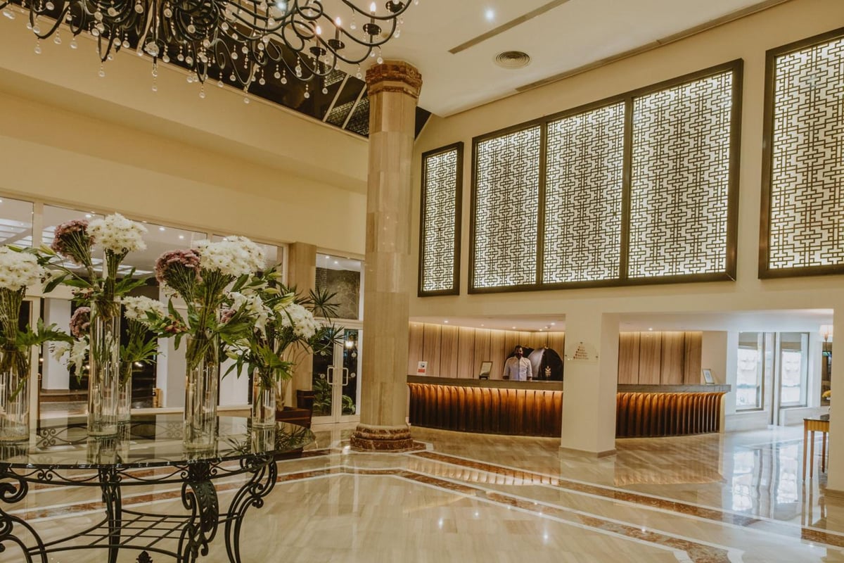 Baron Resort Sharm El Sheikh lobby with patterned wall panels and a chandelier.