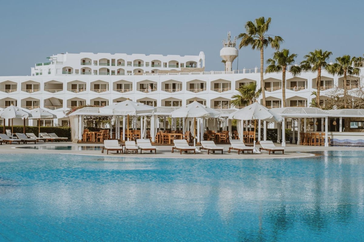 Baron Resort Sharm El Sheikh pool with blue water and shaded cabanas.