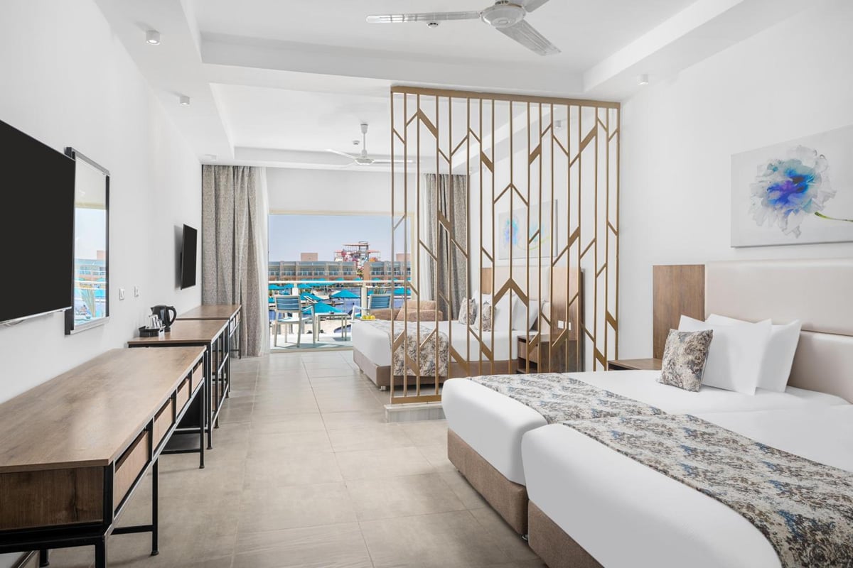 Pickalbatros Sea World Resort Marsa Alam guest room with a wooden screen and balcony.