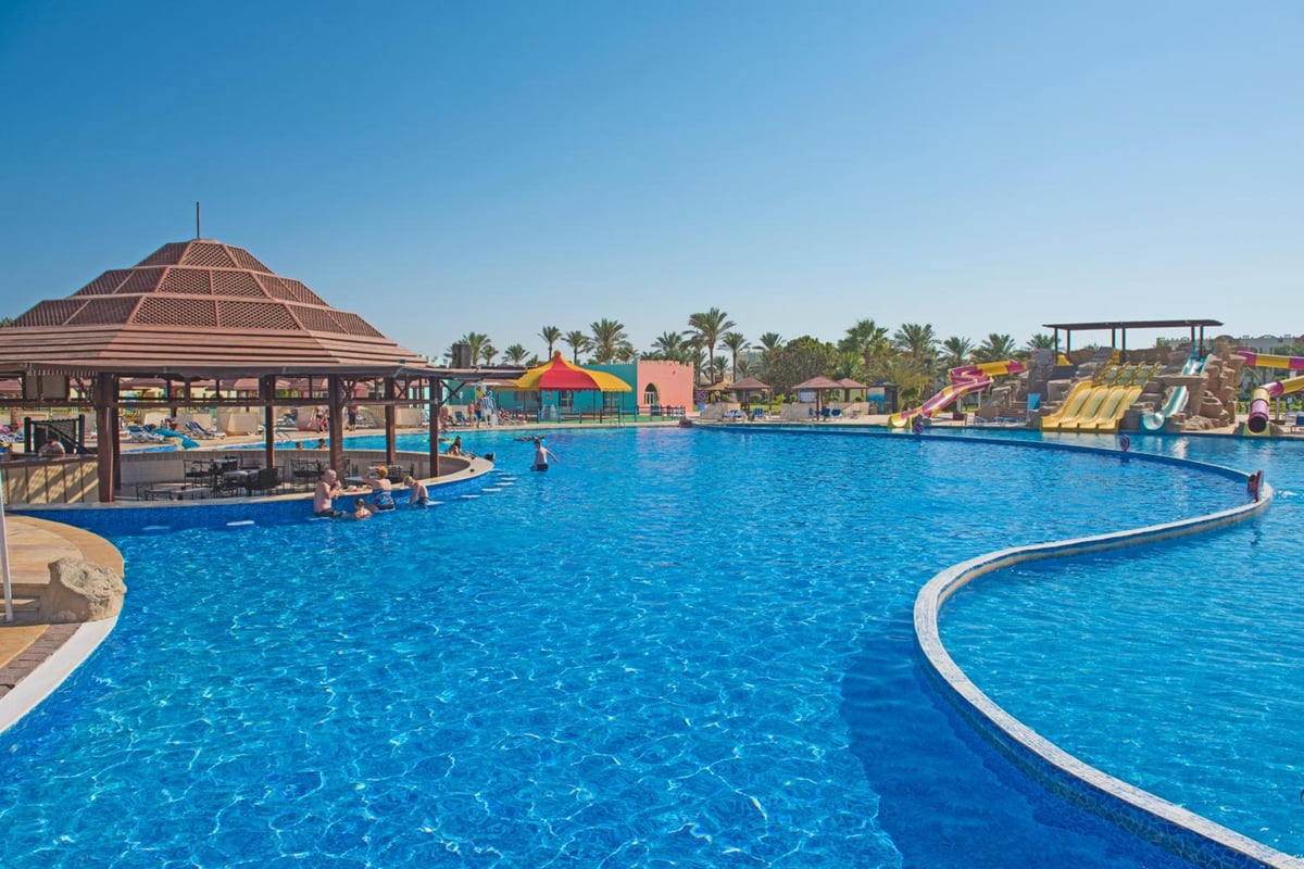 Sunrise Royal Makadi Resort pool with a thatched pavilion and water slides.