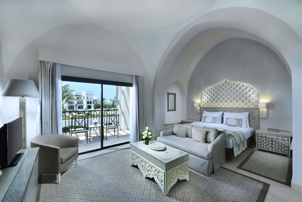 Steigenberger Alcazar guest room with an arched ceiling and balcony.