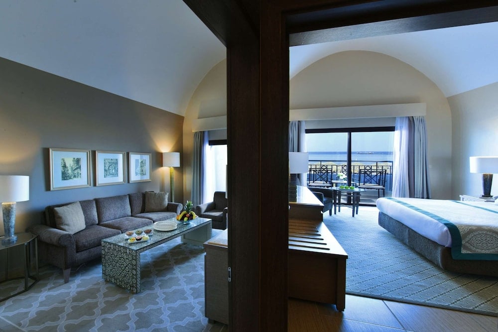 Steigenberger Alcazar guest suite with a sitting area and a balcony.