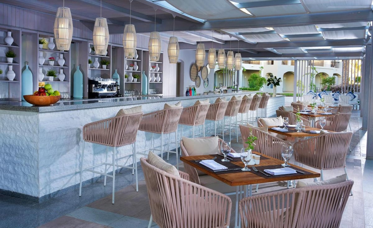 Steigenberger Alcazar restaurant with a long counter and woven chairs.