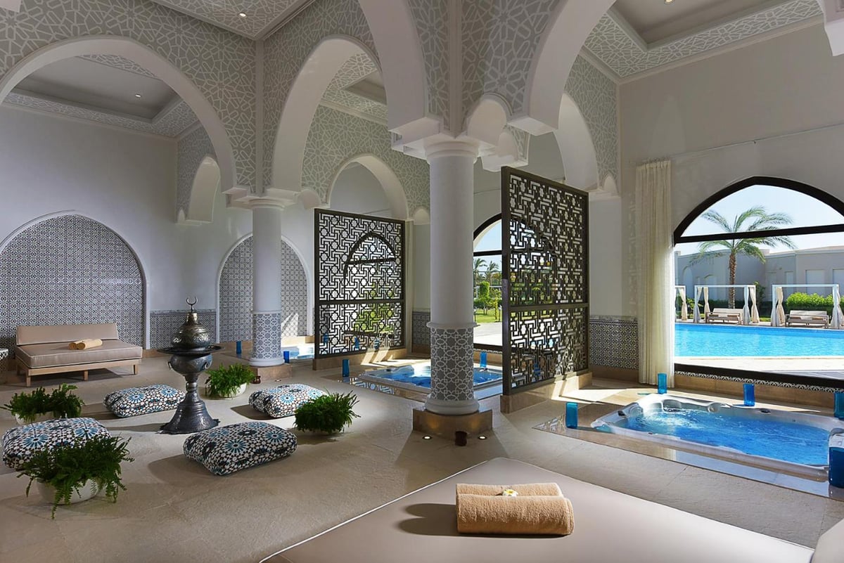 Steigenberger Alcazar pool lounge with patterned arches and a rectangular pool.