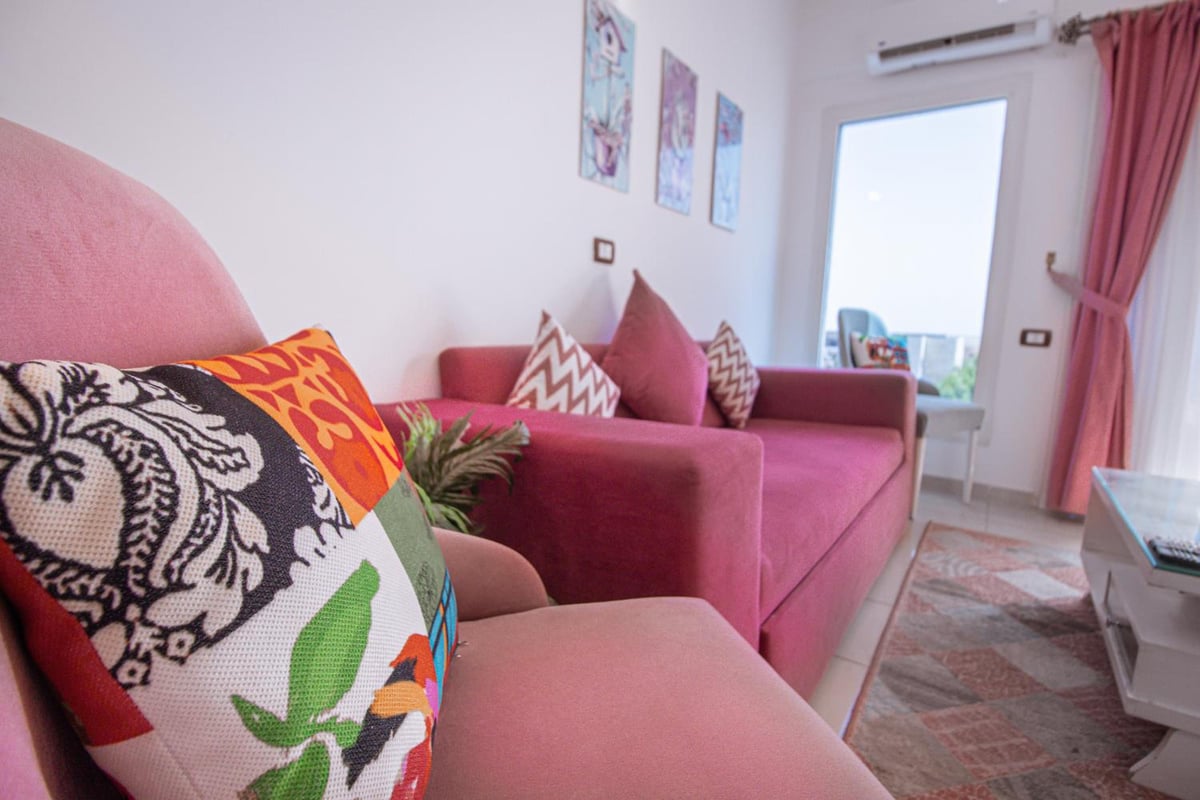 Swiss Royal Dahab living room with a pink sofa and patterned cushions.