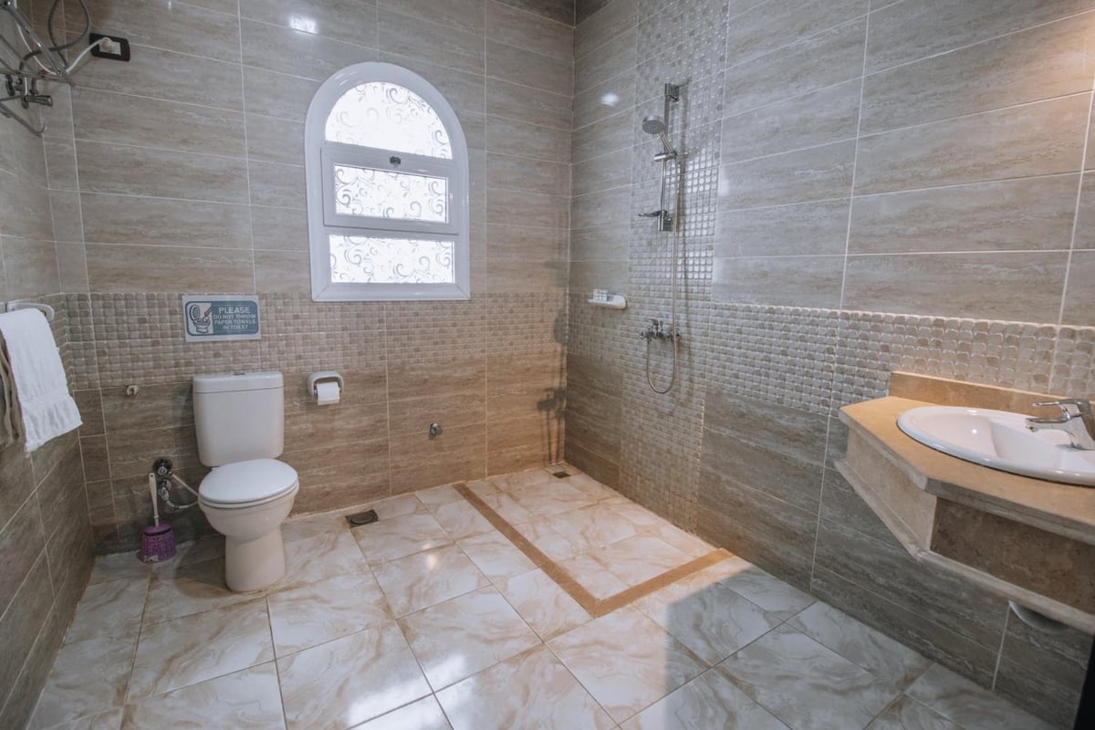 Swiss Royal Dahab bathroom with an open shower and a vanity.