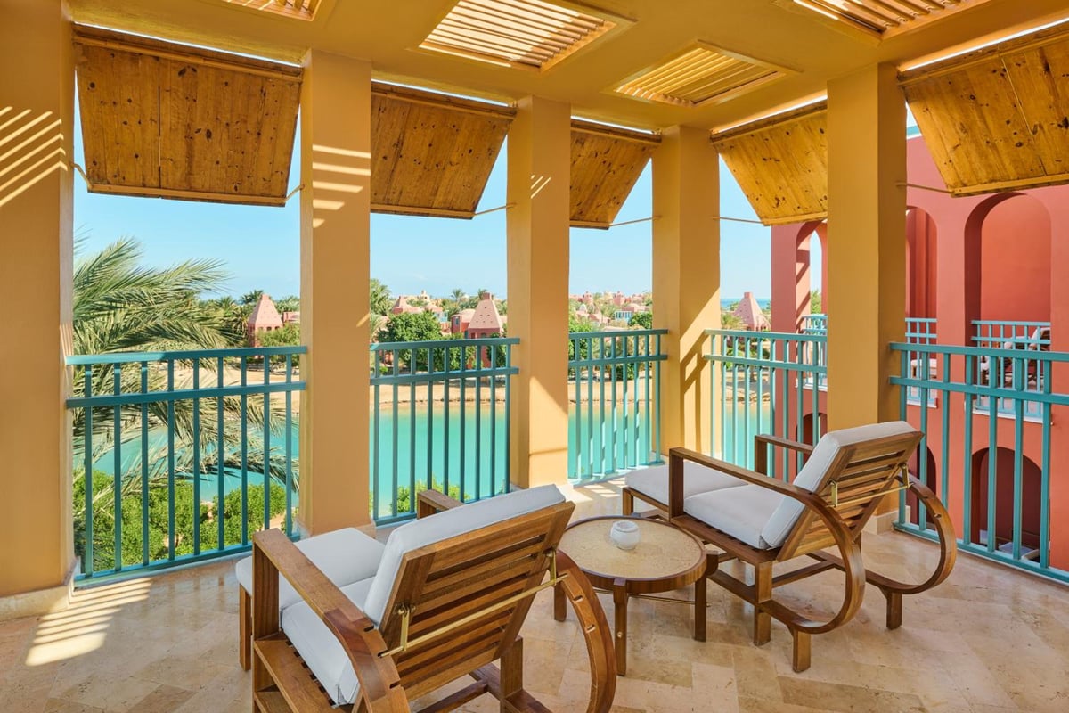 Sheraton Miramar Resort El Gouna balcony with wooden shade panels and a water view.