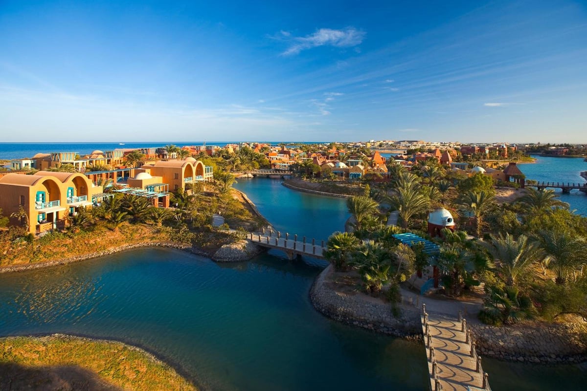 Sheraton Miramar Resort El Gouna lagoon with turquoise water and arched buildings.