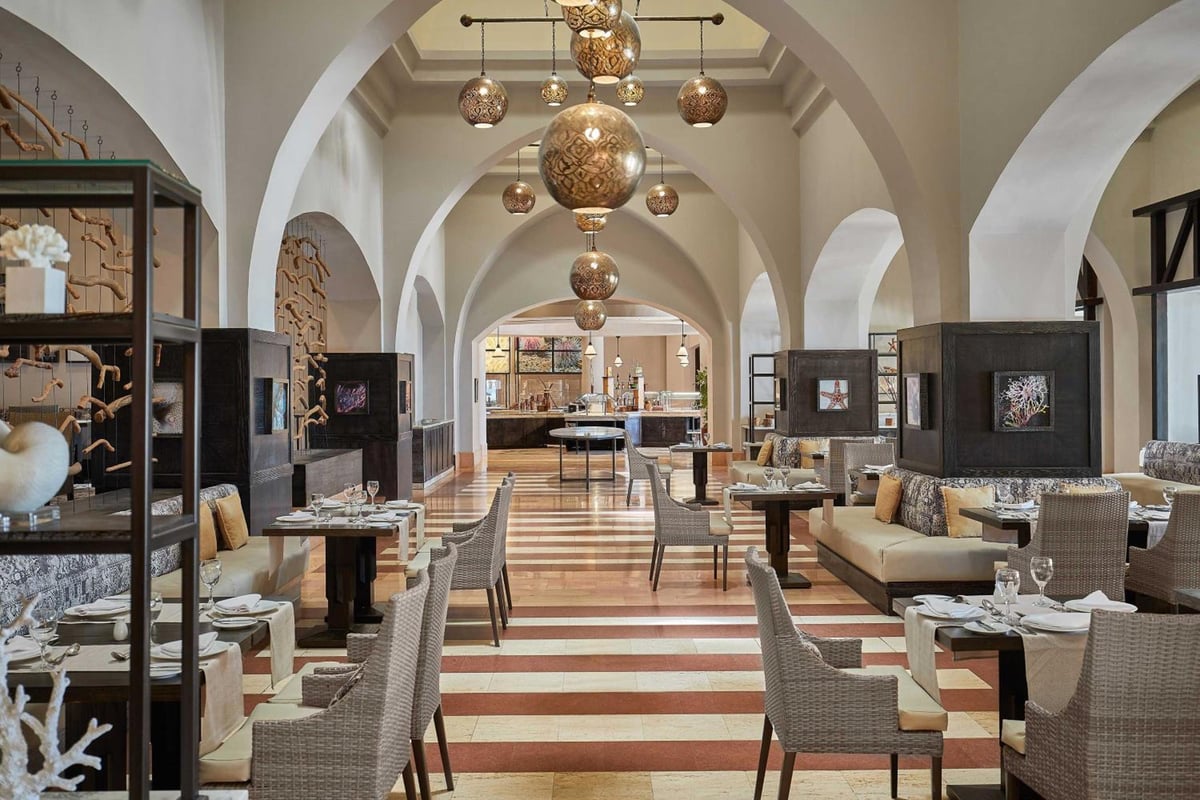 Sheraton Miramar Resort El Gouna restaurant dining room with arched ceilings and hanging lanterns.