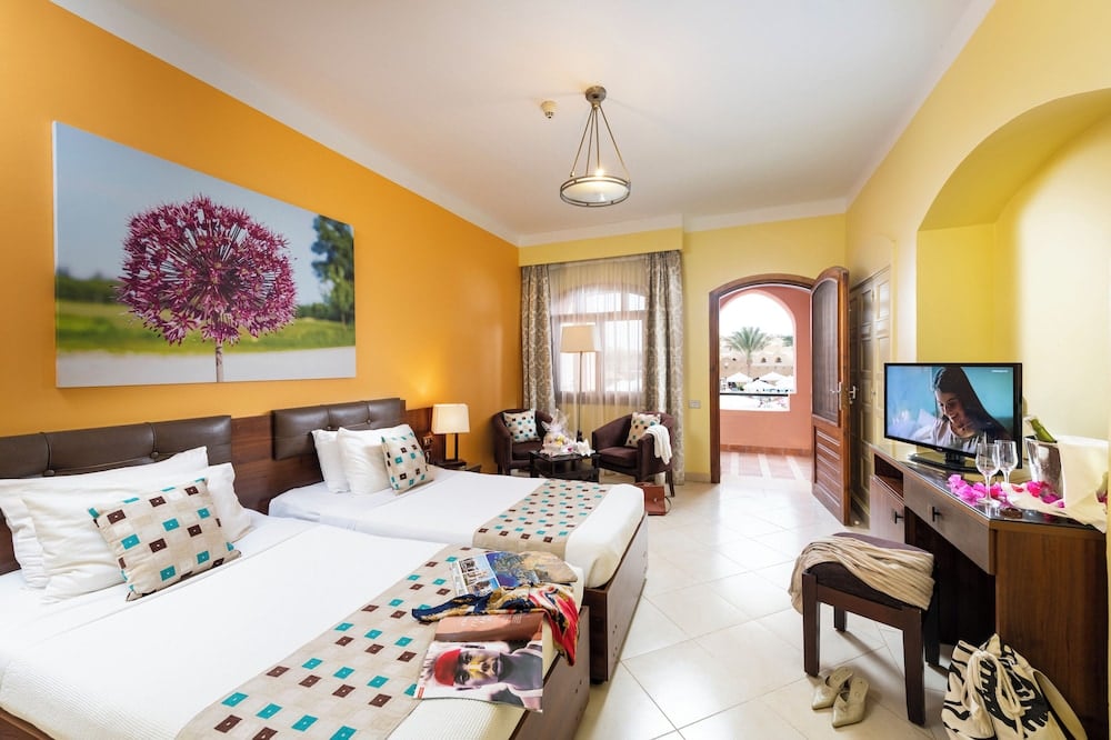 Three Corners Rihana Resort El Gouna twin bedroom with two beds and orange walls.
