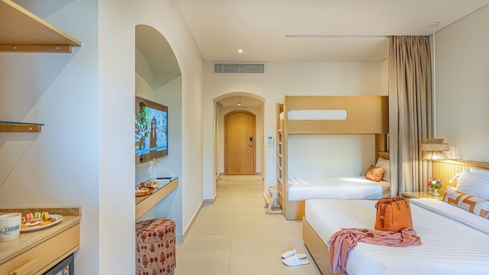 Three Corners Rihana Resort El Gouna family room with a bunk bed and twin beds.