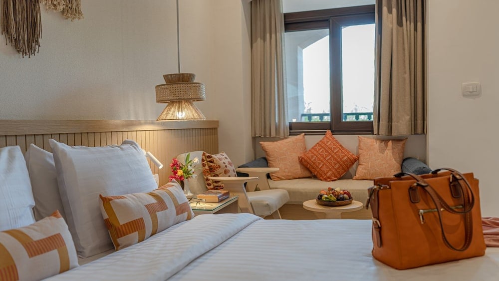 Three Corners Rihana Resort El Gouna guest room with a bed and sitting area.