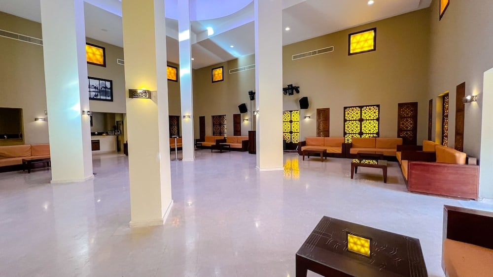 Gemma Resort lobby with tall columns and lounge seating.
