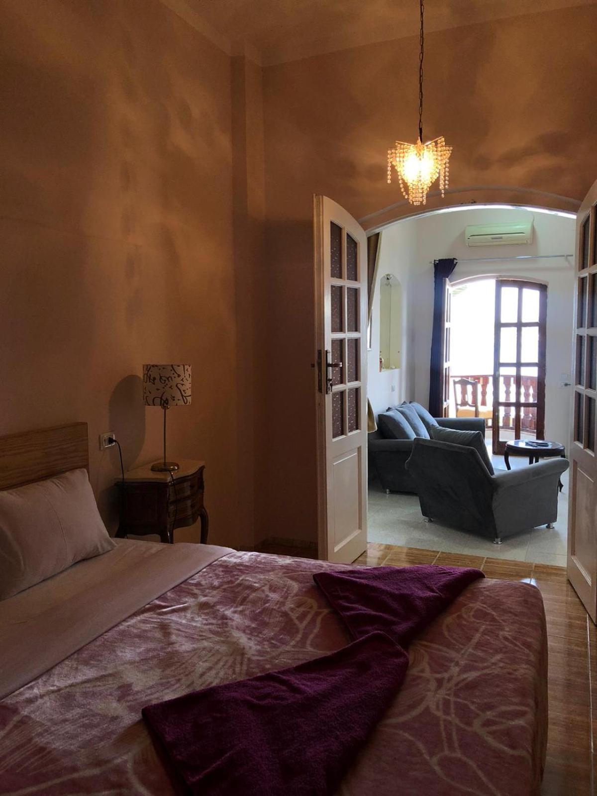 Nile Castle Luxor bedroom with a bed and adjoining sitting area.