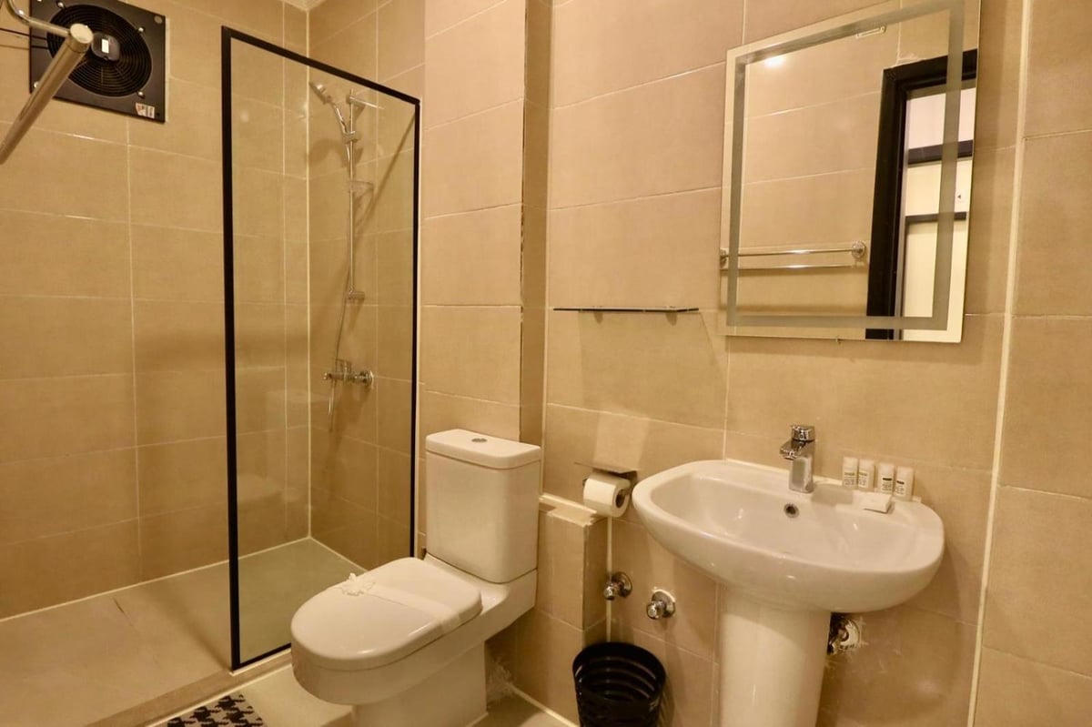 Nile Castle Luxor bathroom with a glass shower and pedestal sink.