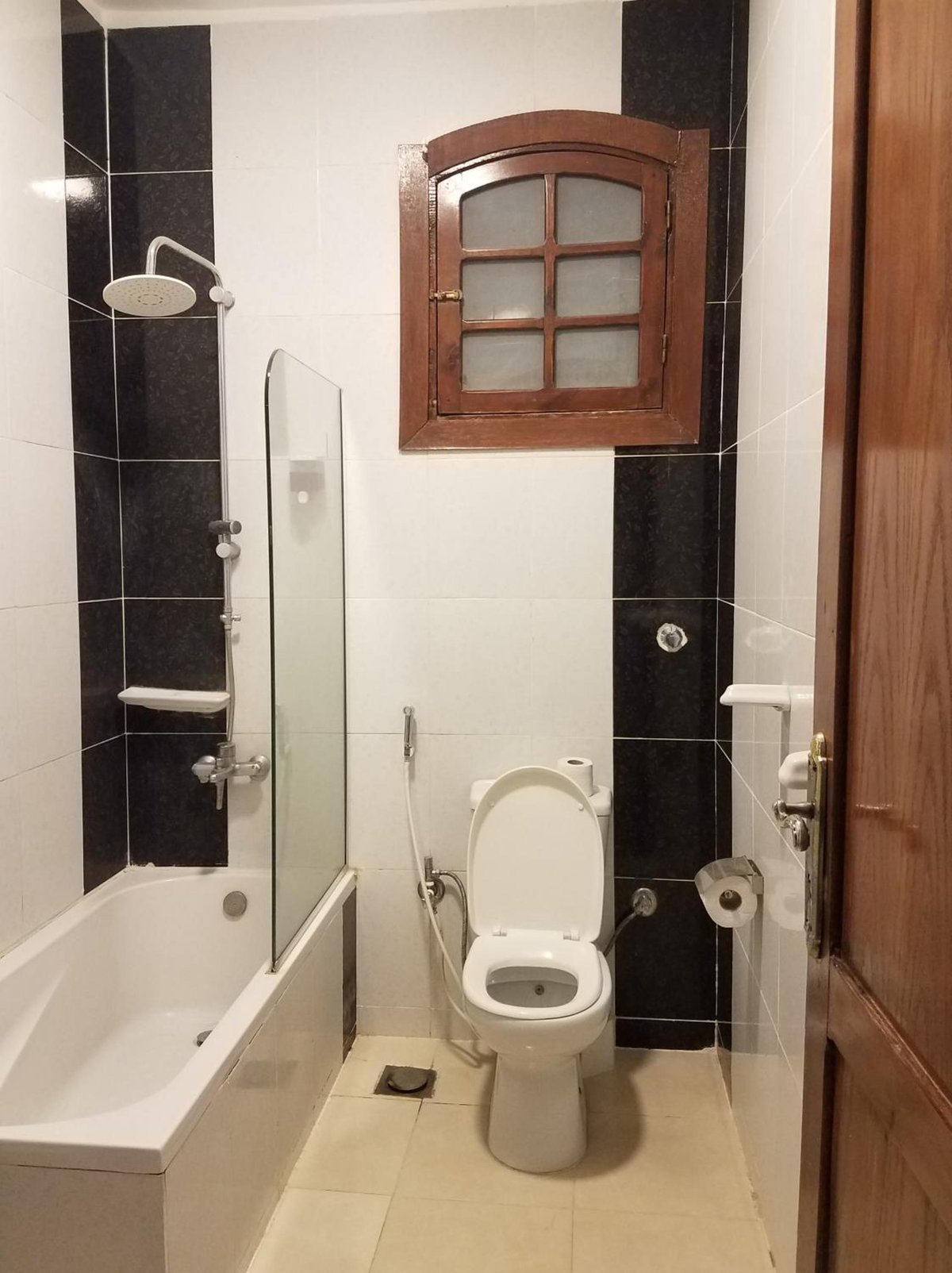 Nile Castle Luxor bathroom with a bath and toilet.