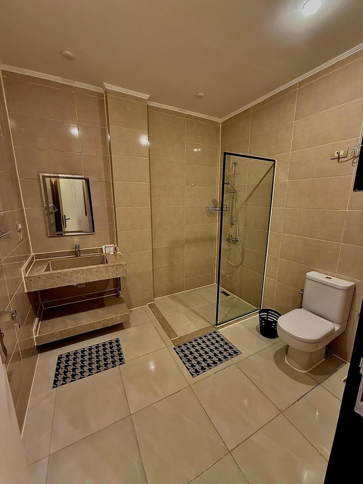 Nile Castle Luxor bathroom with tiled walls and a glass shower enclosure.