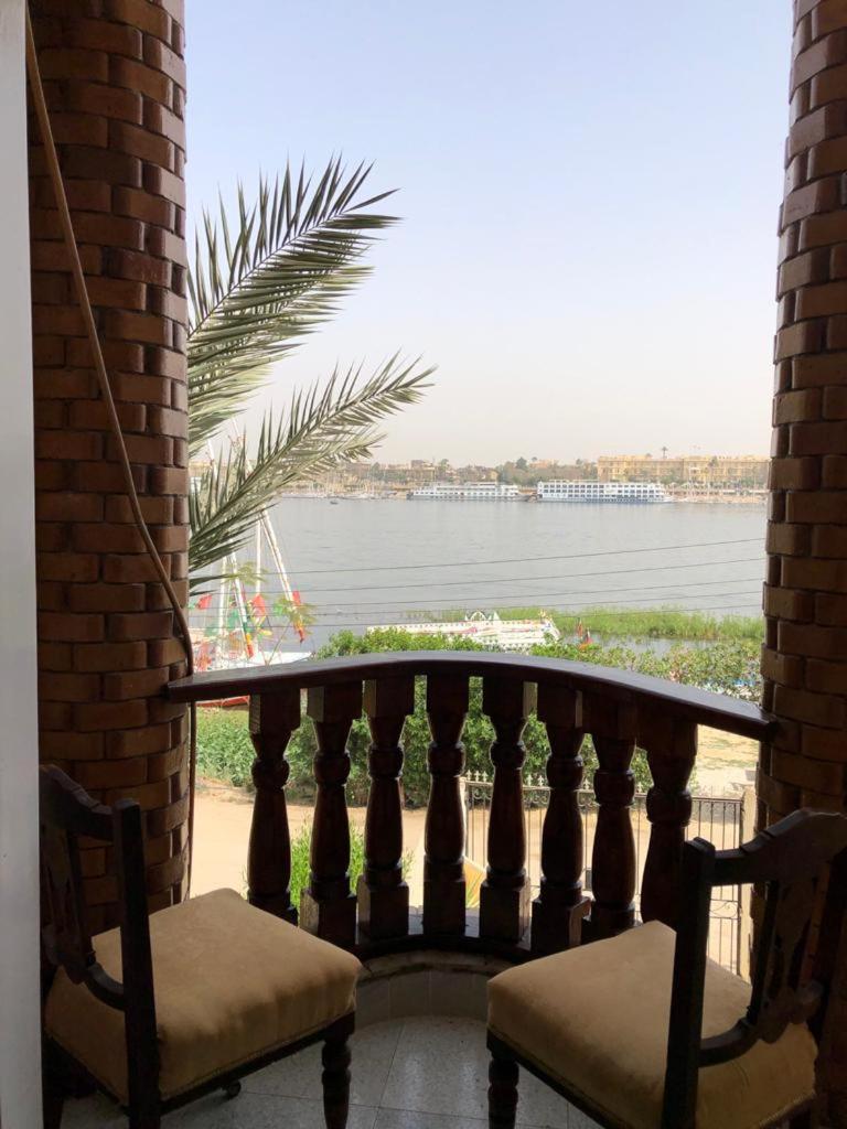 Nile Castle Luxor balcony with brick columns and a river view.