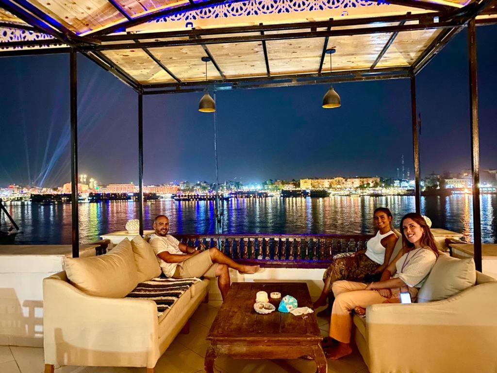 Nile Castle Luxor deck lounge with cushioned sofas and river views.